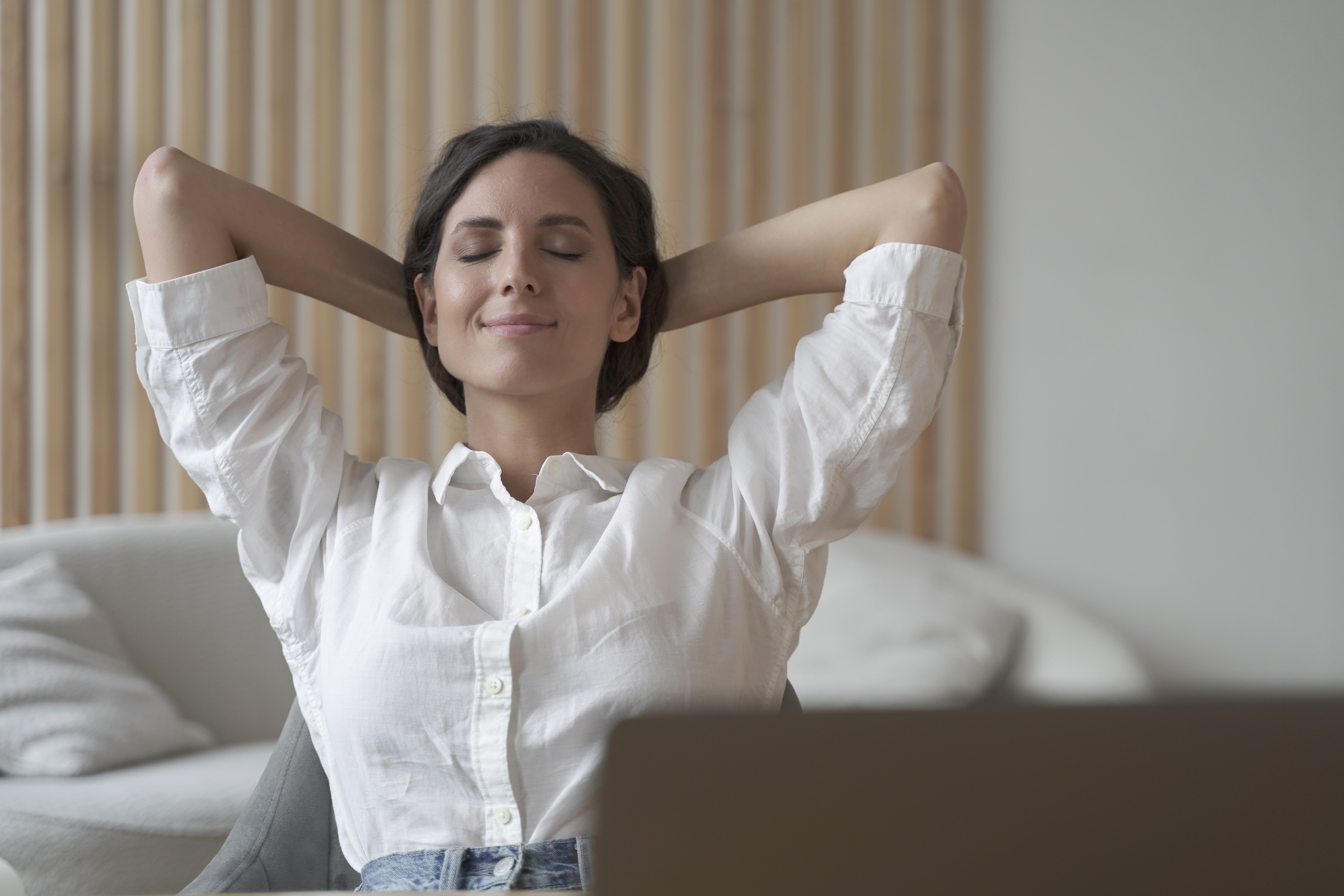 Relaxed woman sitting back after doing vagus nerve exercises